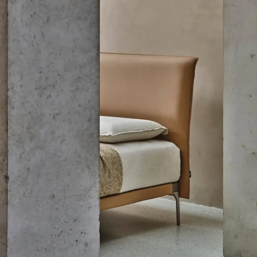 Distinguished Ditre Italia Ada bed with a slimline headboard upholstered in smooth tan leather or synthetic material and dark metal legs