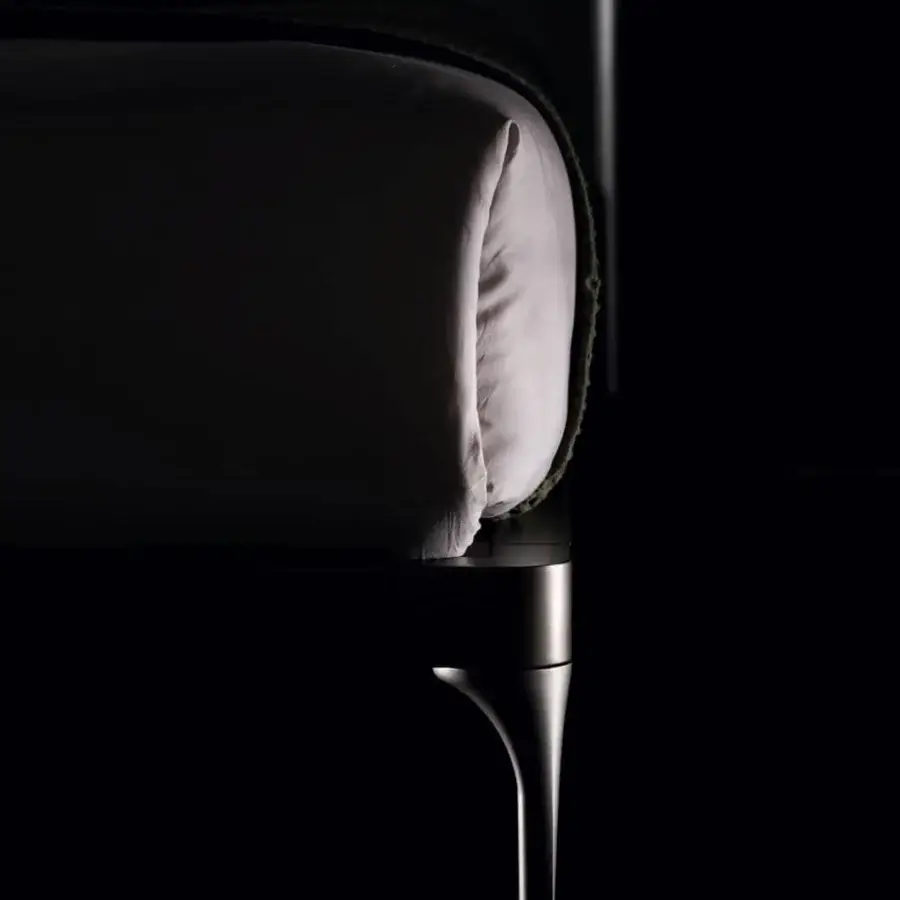 Exclusive Ditre Italia Ada bed with a slimline headboard upholstered in light textile with a dark green blanket and curved polished metal leg