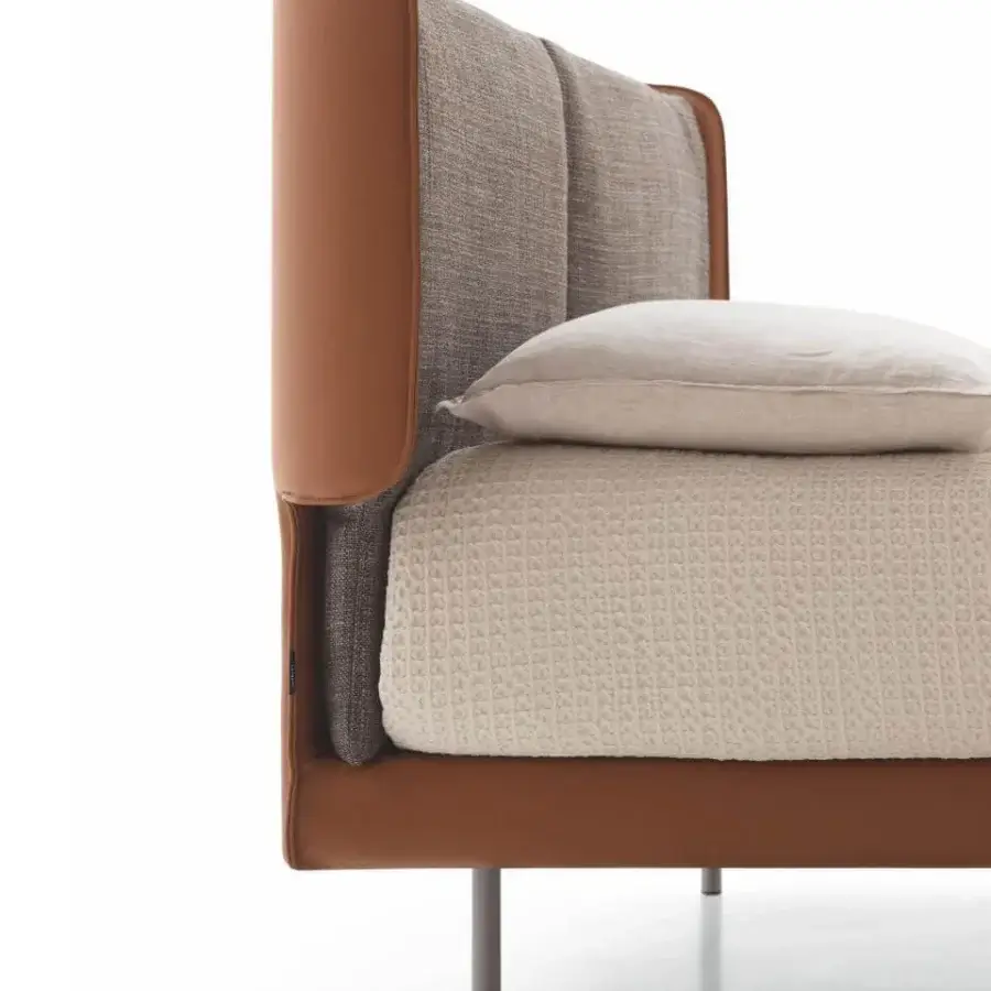 Superior Ditre Italia Skin bed with brown leather bordering vertically divided textile upholstery and dark slender legs