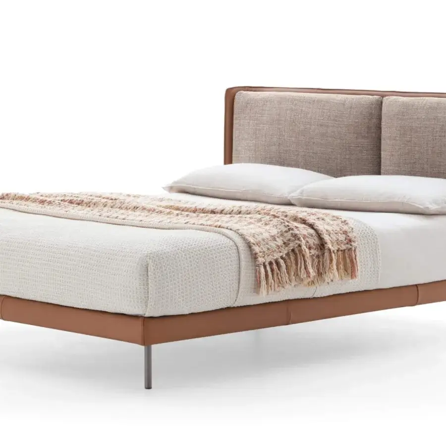 Distinguished Ditre Italia Skin bed with smooth brown leather upholstery and textured fabric cushions exhibiting sleek dark metal legs