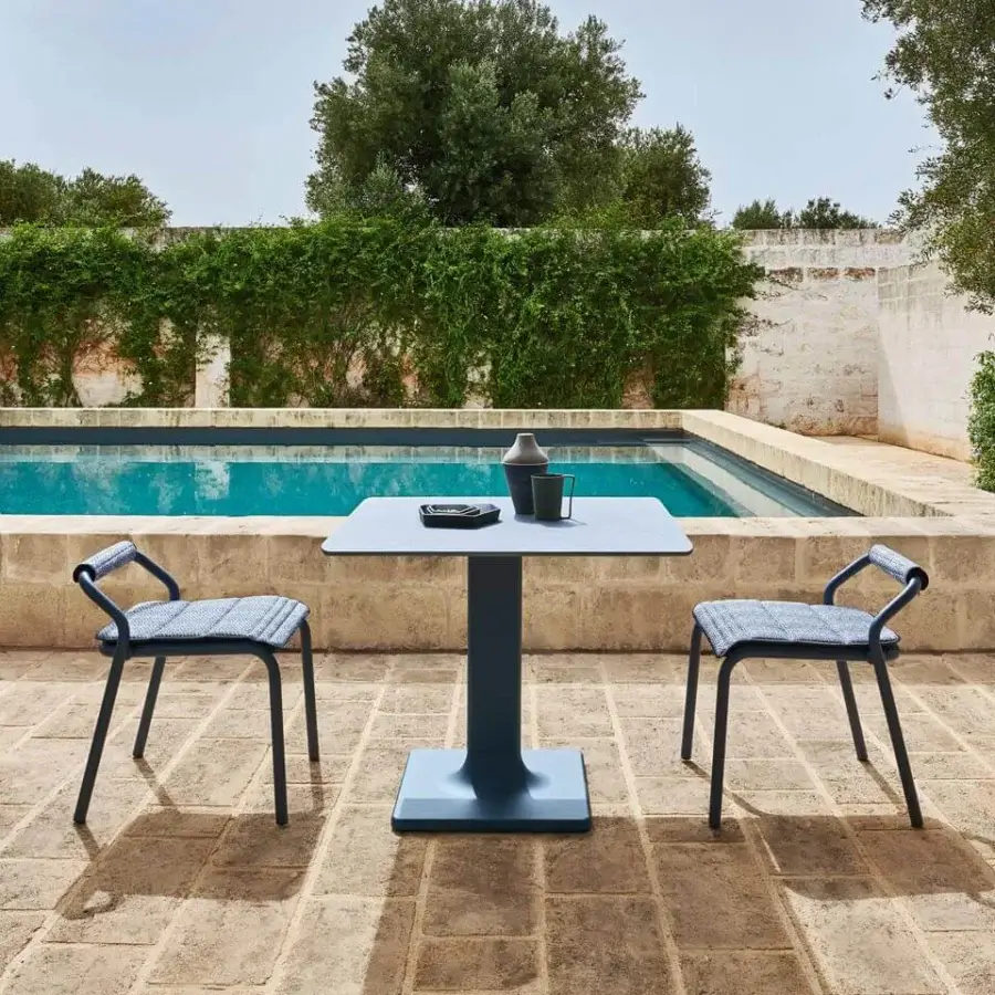 Elegant Varaschin Noss chair with geometric silhouette in dark teal powder coated aluminum and quilted seat