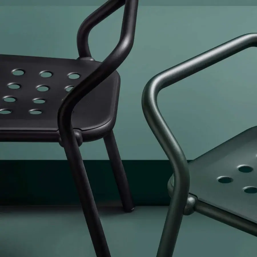 Distinguished Varaschin Noss chair with black powder-coated aluminum, exhibiting curved lines and oval perforations for outdoor use