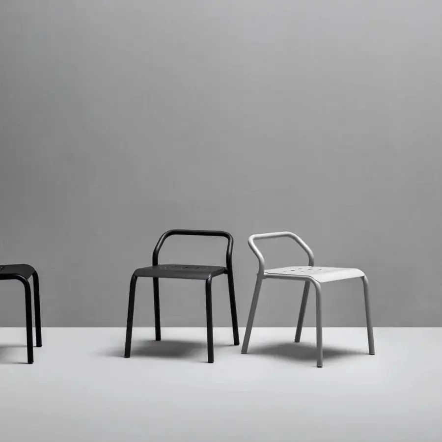 Elegant Varaschin Noss chair with light gray powder-coated aluminum exhibiting curved lines and perforated seat construction
