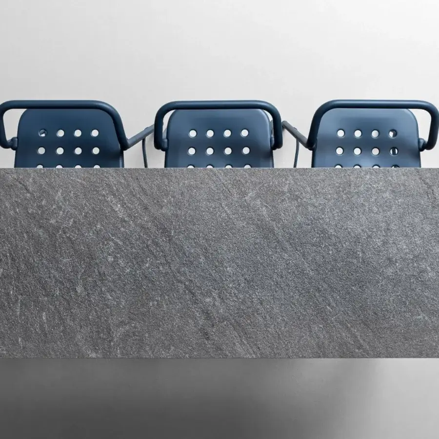 Refined Varaschin Noss stool with a powder-coated aluminum seat and dark metal frame supporting a rounded dark blue backrest