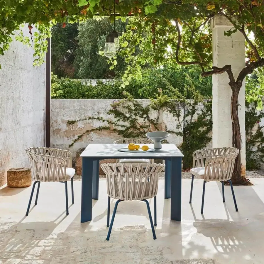 Distinguished Varaschin Plinto table with square tabletop crafted in light grey bush-hammered ceramic and muted blue-grey powder-coated aluminum