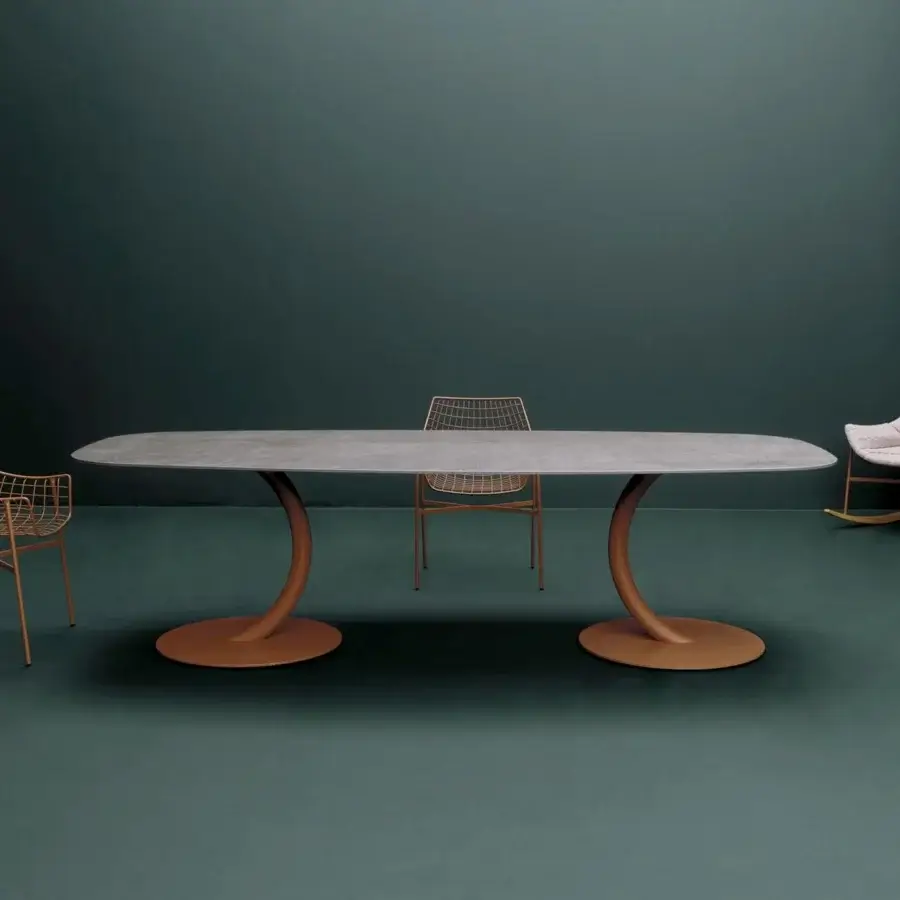 Distinguished Varaschin Flexion table with oval light gray HPL top and gracefully curved orange powder-coated legs