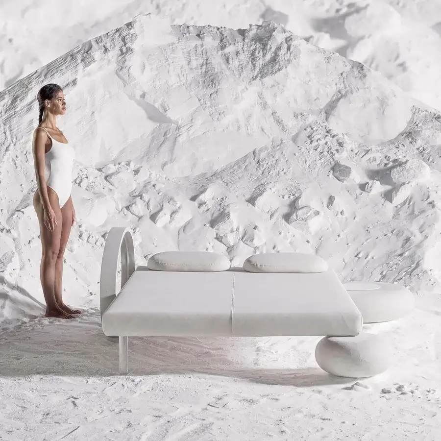 Distinguished Varaschin Wellness Therapy bed with white finish and curved headboard resting on stones