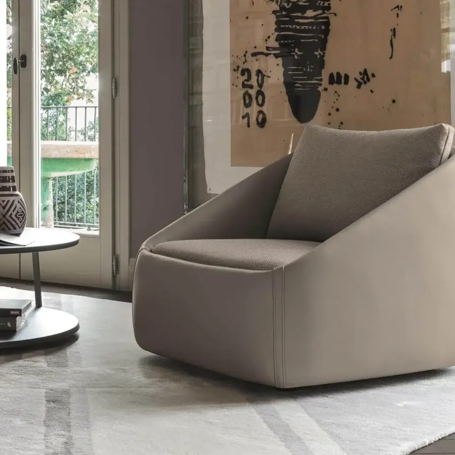Sophisticated Ditre Italia Bend lounge chair fully upholstered in light taupe leather with soft geometric shapes and sartorial stitched corners