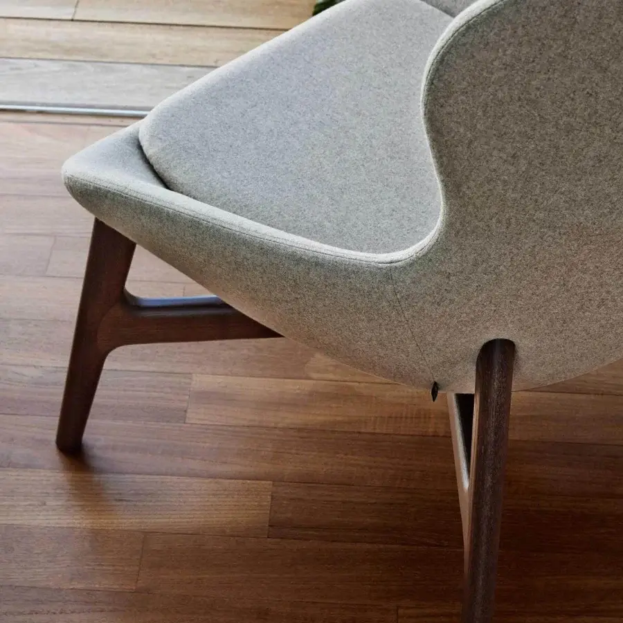 Superior Ditre Italia Round Lounge Chair with wraparound shape upholstered in light gray fabric and dark brown wooden base