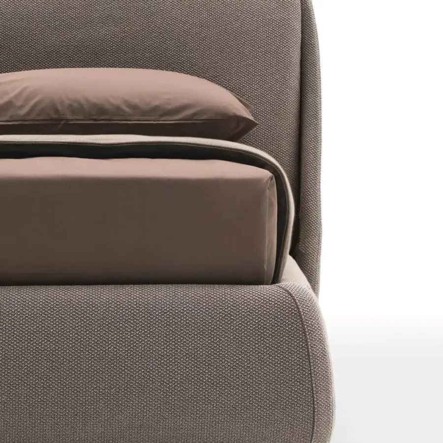 Distinguished Ditre Italia Bend bed with a textured taupe woven textile and curved silhouette, built with a rigid headboard