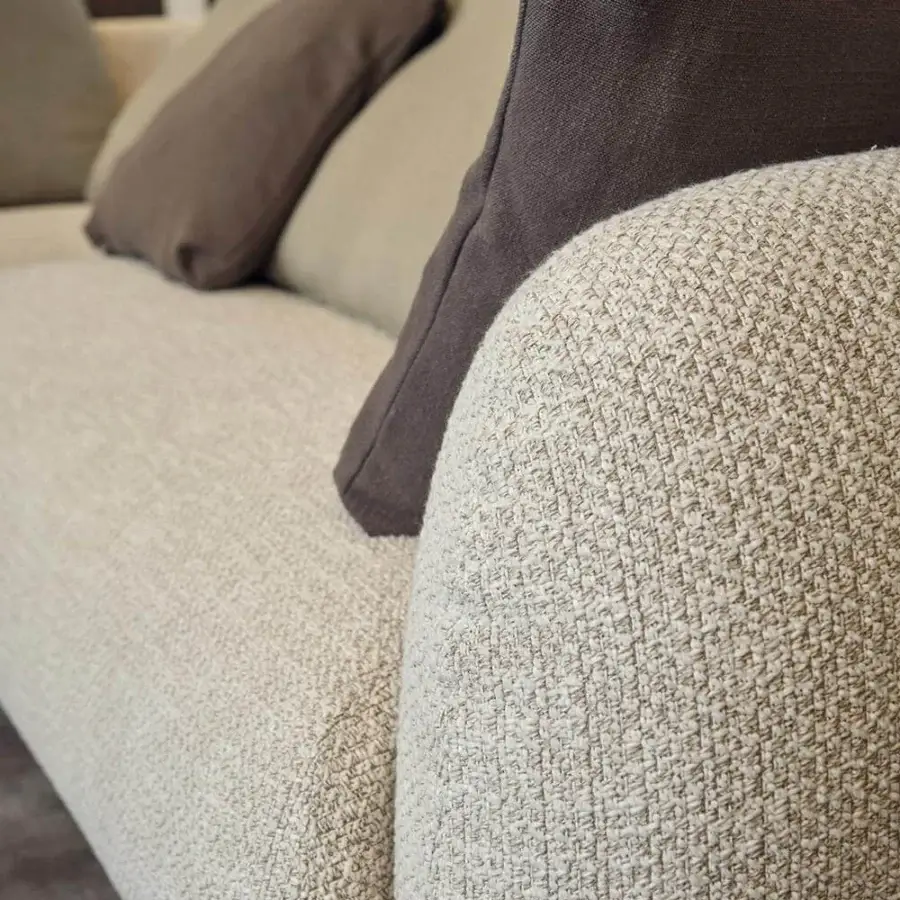 Distinguished Presotto Bali sofa upholstered in light beige textured fabric with Peltro painted feet and darker brown cushions