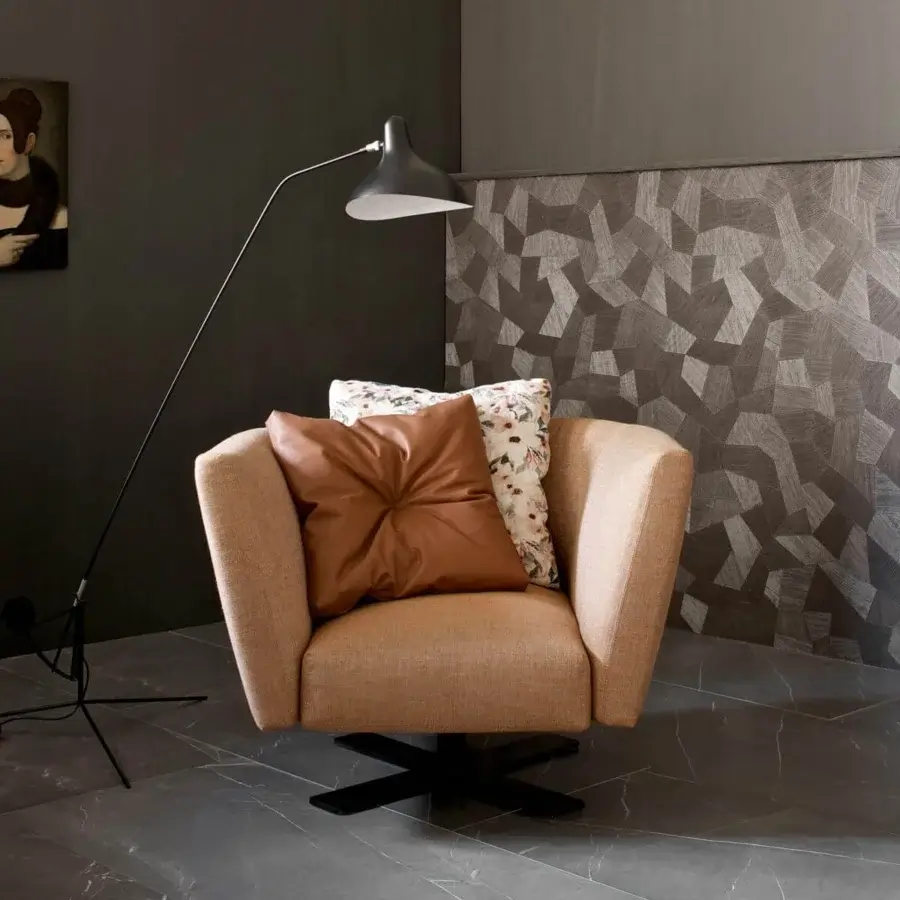 Distinguished Presotto Saint Barth lounge chair with light brown textile and a Peltro finish swivel base, including tufted and floral cushions