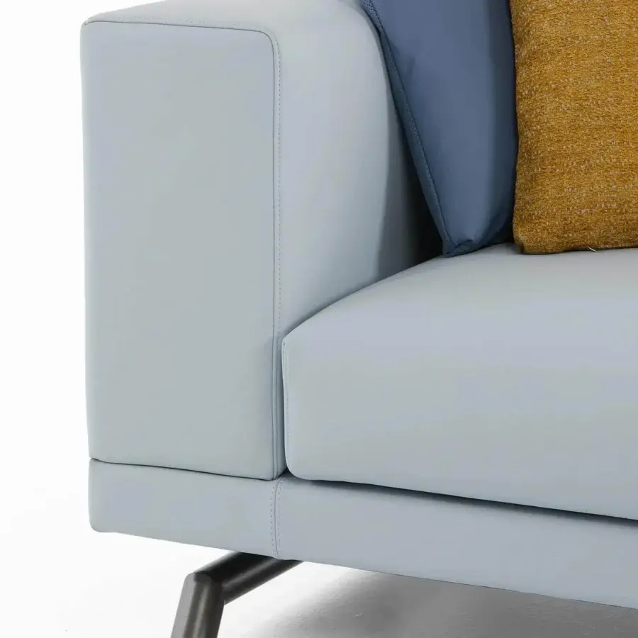 Distinguished Presotto San Marino sectional with light blue-gray synthetic upholstery, navy and mustard pillows, plus peltro varnished metal feet