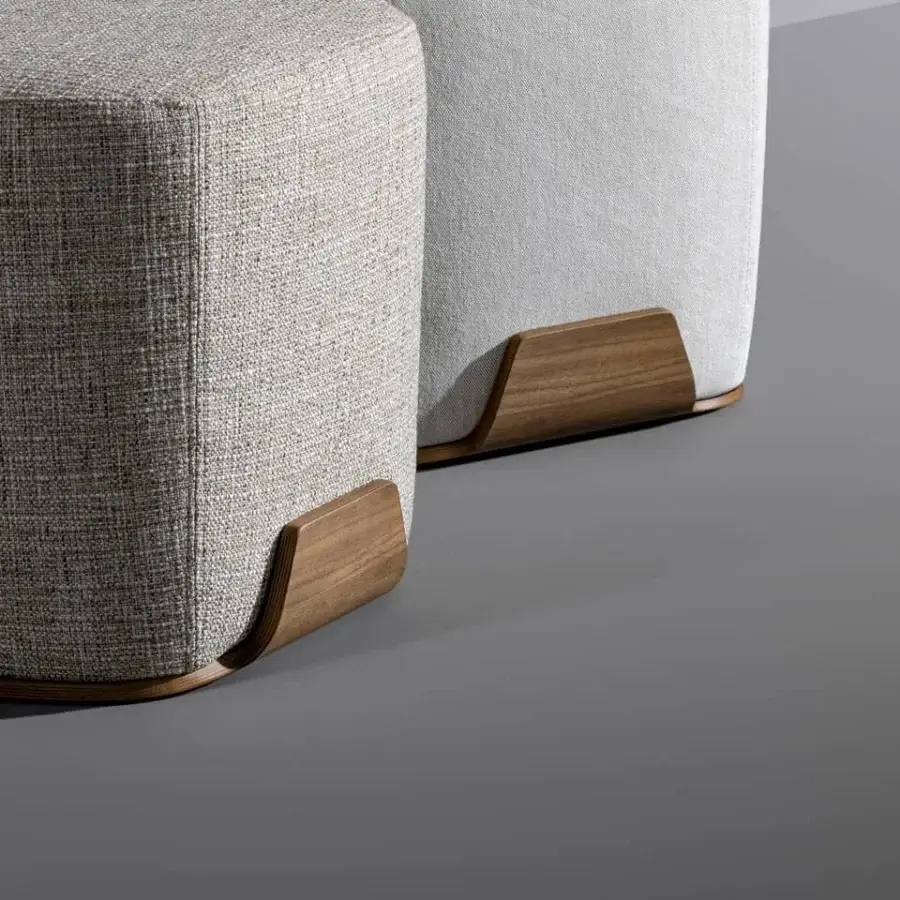 Harmonious Bonaldo Olos ottoman with curved Canaletto Walnut base and light gray textile upholstery exhibiting a uniform finish