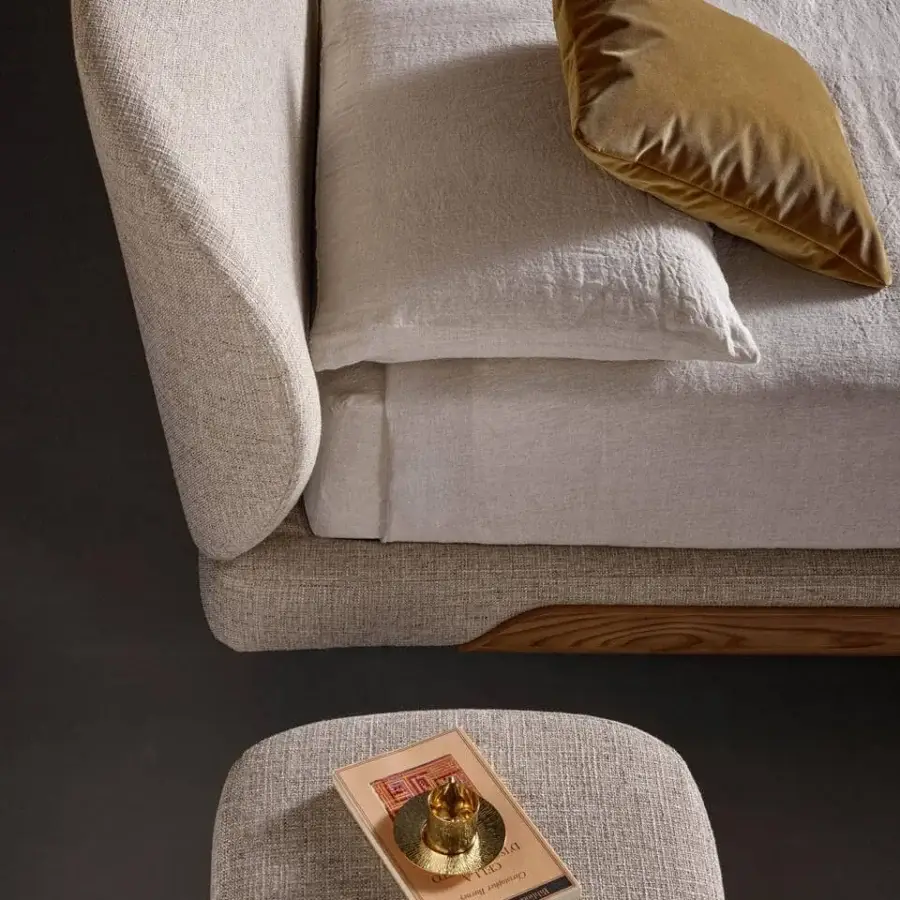 Distinguished Bonaldo Olos bed upholstered in light beige textile with textured finish and curved Canaletto Walnut wood accents