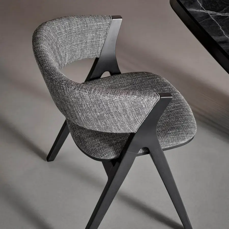 Distinguished Bonaldo Remo chair with a curved back and sleek legs crafted in textured gray fabric with a matte coal finished solid ash wood frame