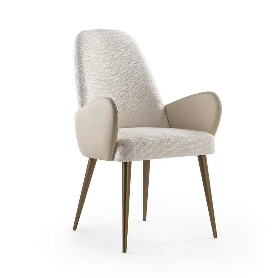 Atlantic Armchair, off-white textured fabric, light beige leather arms, curved silhouette, tapered brushed brass legs, studio shot.