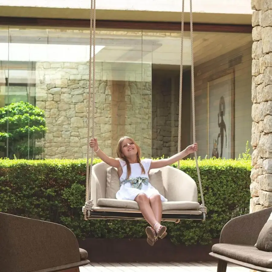 Distinguished Talenti Cleo Swing seating with teak wood structure and removable beige weather-resistant upholstery