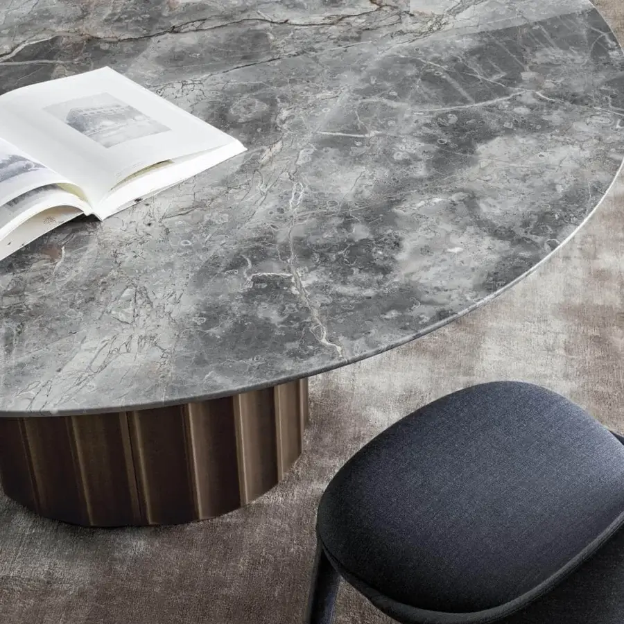Superior Bonaldo Dorian table with round marble top showcasing grey and white veining and cylindrical fluted base in bronze or dark brown finish