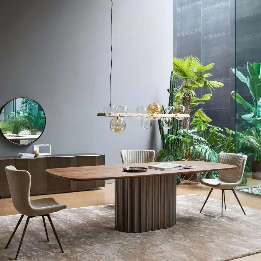 Refined Bonaldo Dorian table with shaped wood top and sculptural grooved base in medium brown matte finish