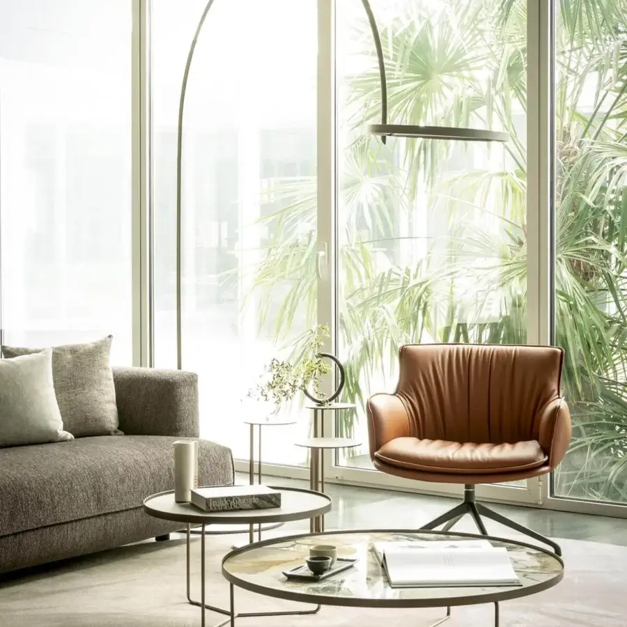 Lavish Cattelan Italia Rhonda lounge chair in supple medium-brown leather with a dark metal swivel base