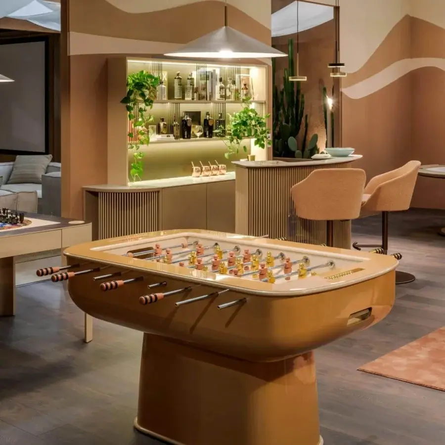 Elegant Vismara Oskar foosball table with glossy caramel lacquered structure and precision-turned beige aluminum players on tempered glass