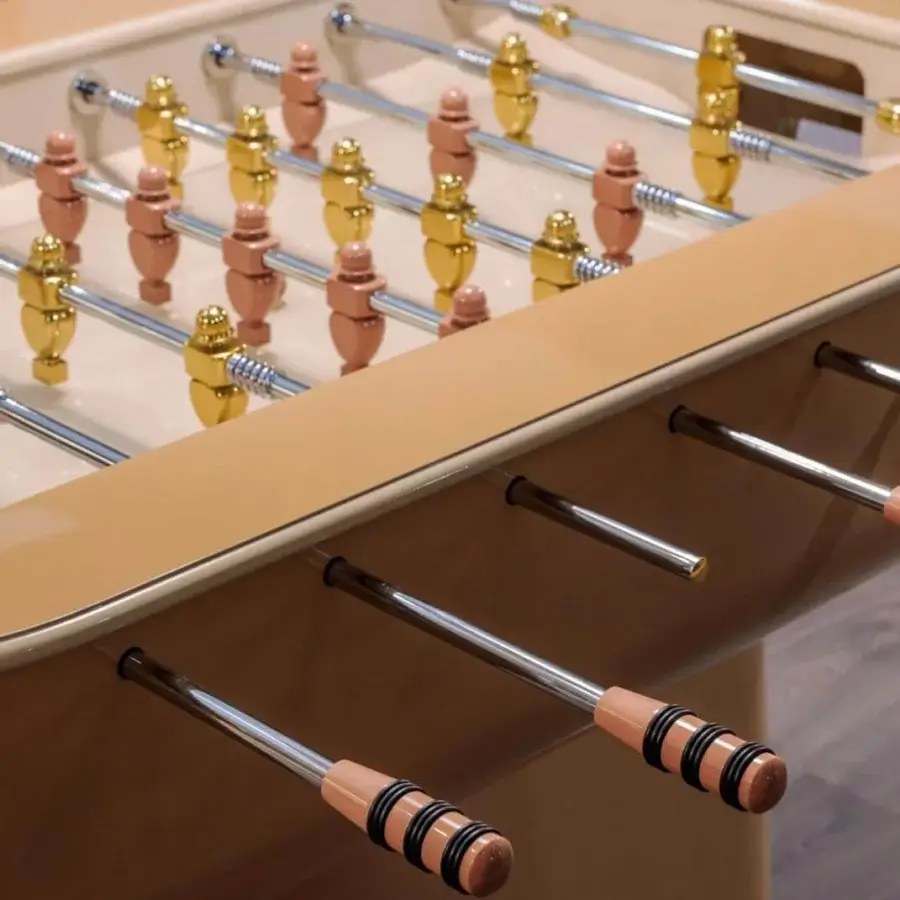 Superior Vismara Oskar foosball table with glossy tan lacquered structure and rose-gold finished steel rotating bars with black accents