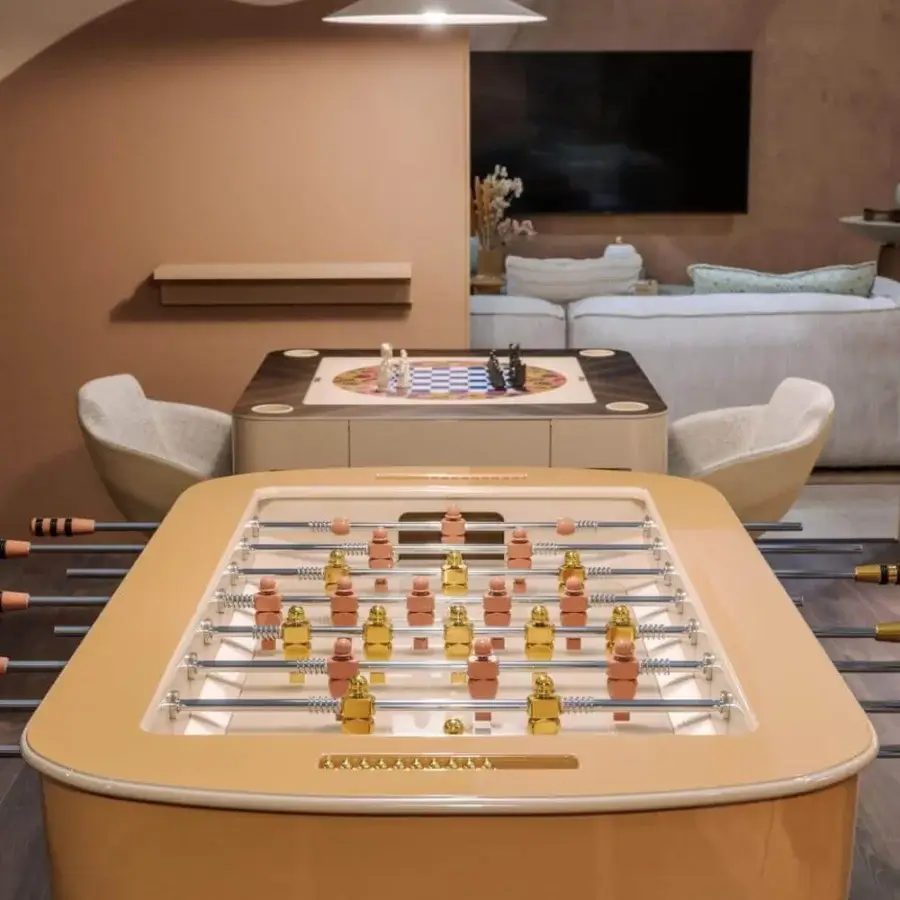 Exclusive Vismara Oskar foosball table with glossy light brown lacquered structure and precision aluminum players in gold and reddish-brown steel