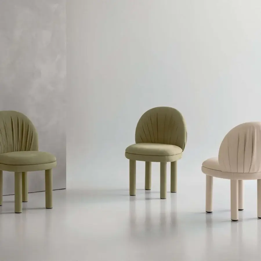 Elegant Rugiano Fandango chair with light beige leather upholstery and refined folds detailing the backrest