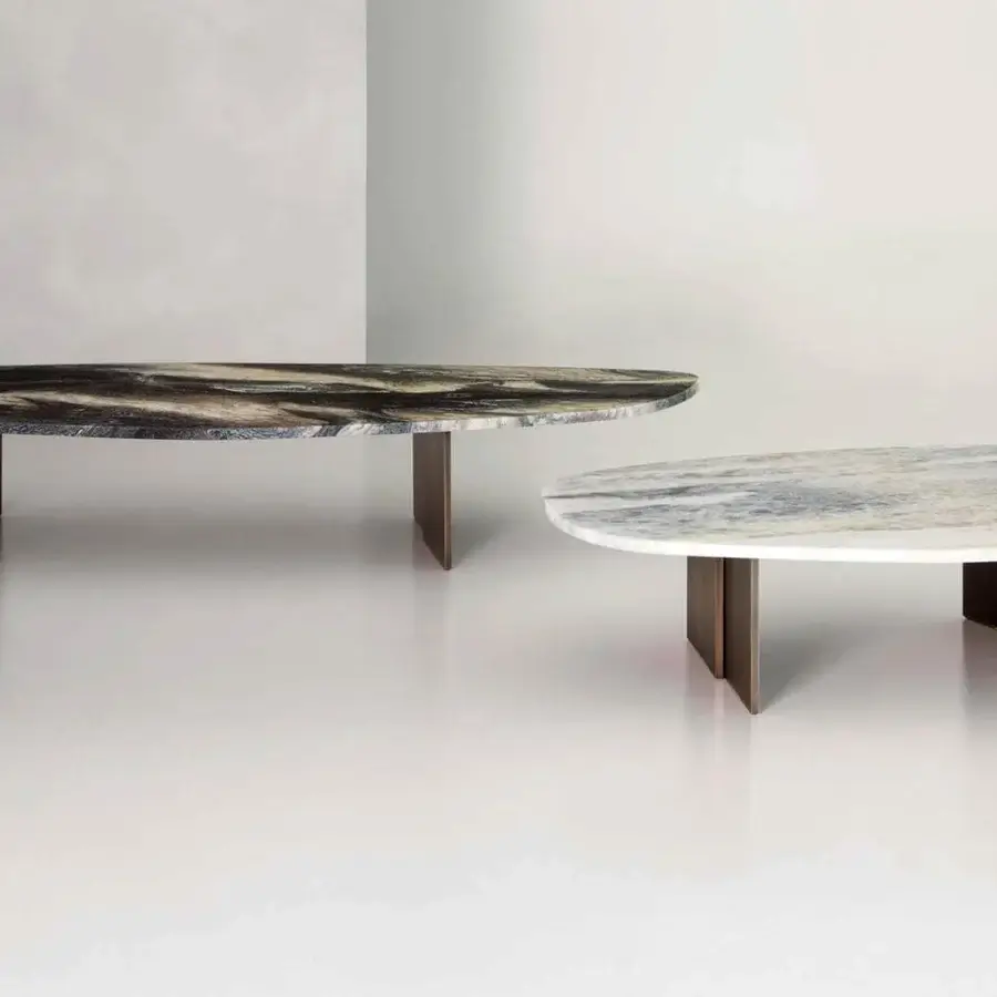 Distinguished Rugiano Rock coffee table with a dark swirling stone-like oval top and bronzed brass metal legs
