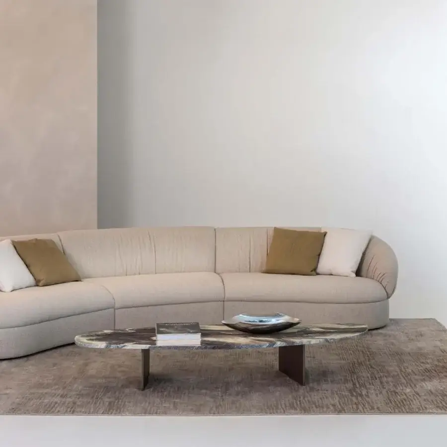 Distinguished Rugiano Rock coffee table with dark gray, brown, and cream toned marble and bronzed brass metal legs