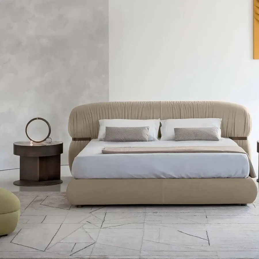 Distinguished Rugiano Fandango bed with delicate lines and soft light beige upholstery crafted in plush leather with bronzed brass detail