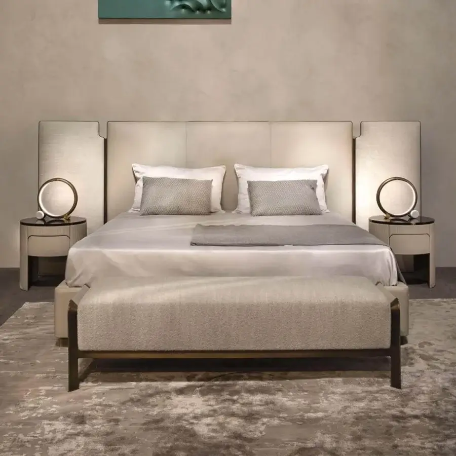 Distinguished Rugiano Falcon bed with light beige textile upholstery and refined bronze brass metal frame details