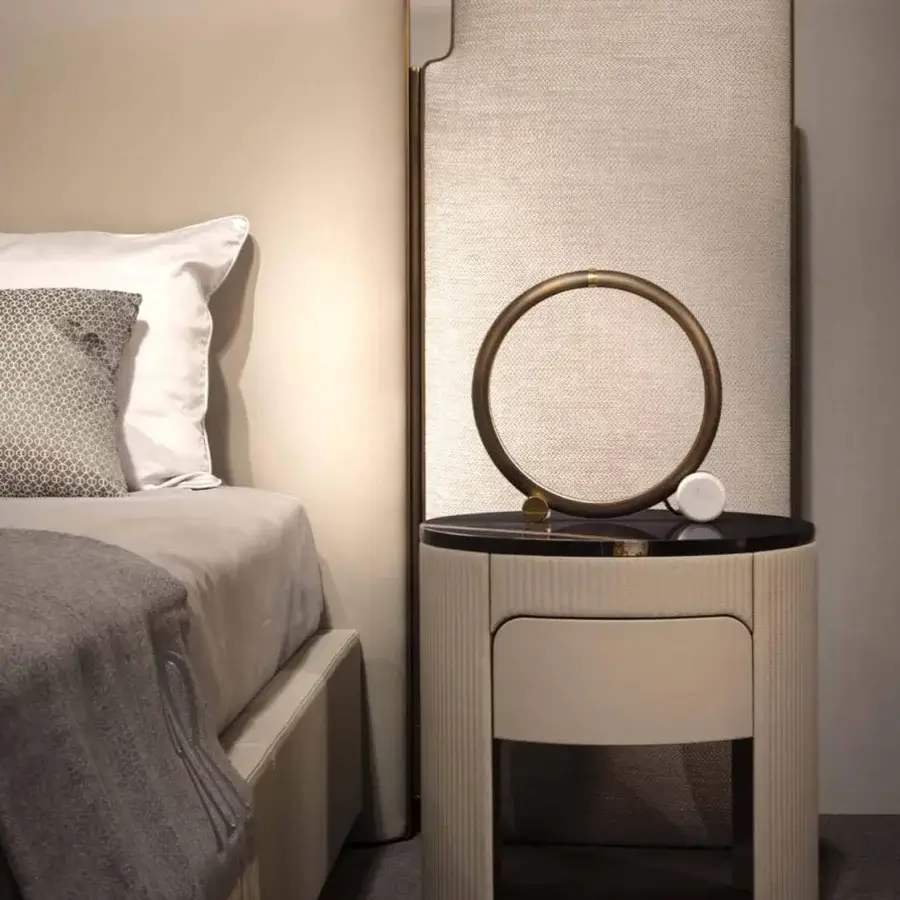 Lavish Rugiano Falcon bed with light beige textile upholstery and bronze brass framing details