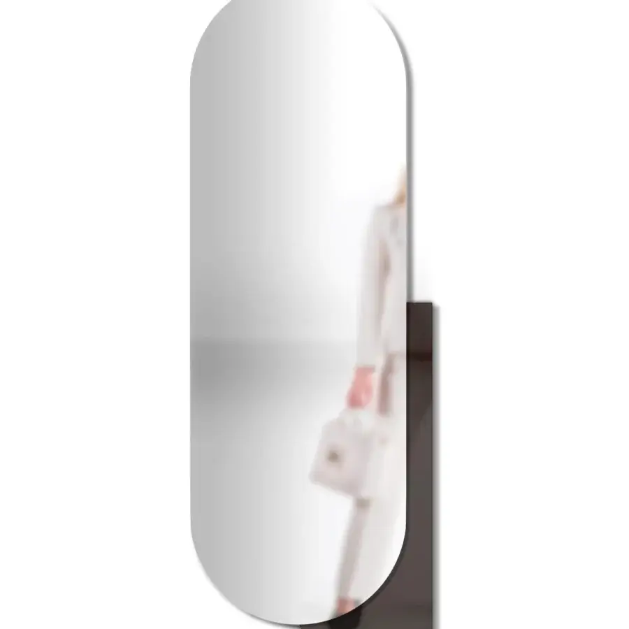 Distinguished Arketipo Karma mirror with tall capsule form and dark supporting structure in transparent and smoked glass