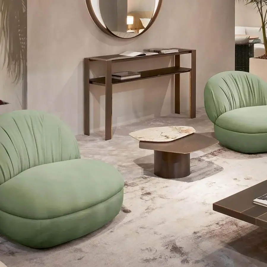 Distinguished Rugiano Fandango lounge chair with light green textile upholstery and bronze brass metal accents