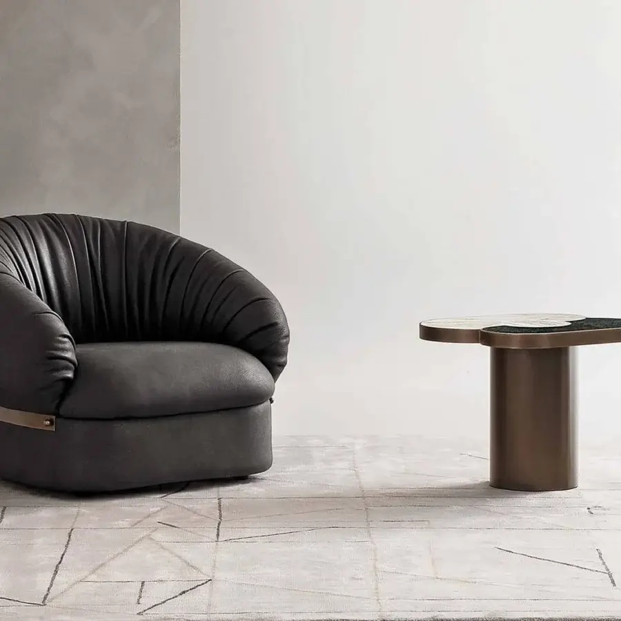 Lavish Rugiano Fandango lounge chair with dark gray leather upholstery and bronze brass metal band detailing