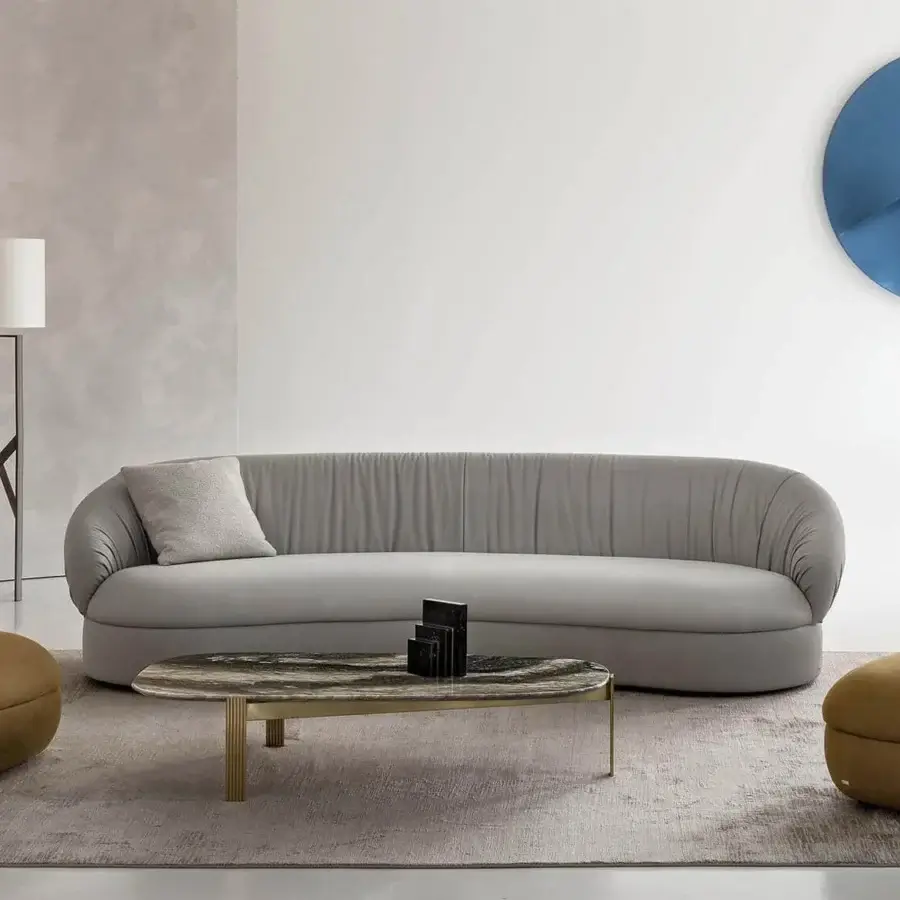 Distinguished Rugiano Fandango sofa with rounded shapes, light gray leather upholstery and a bronze brass metal band with a smooth matte finish