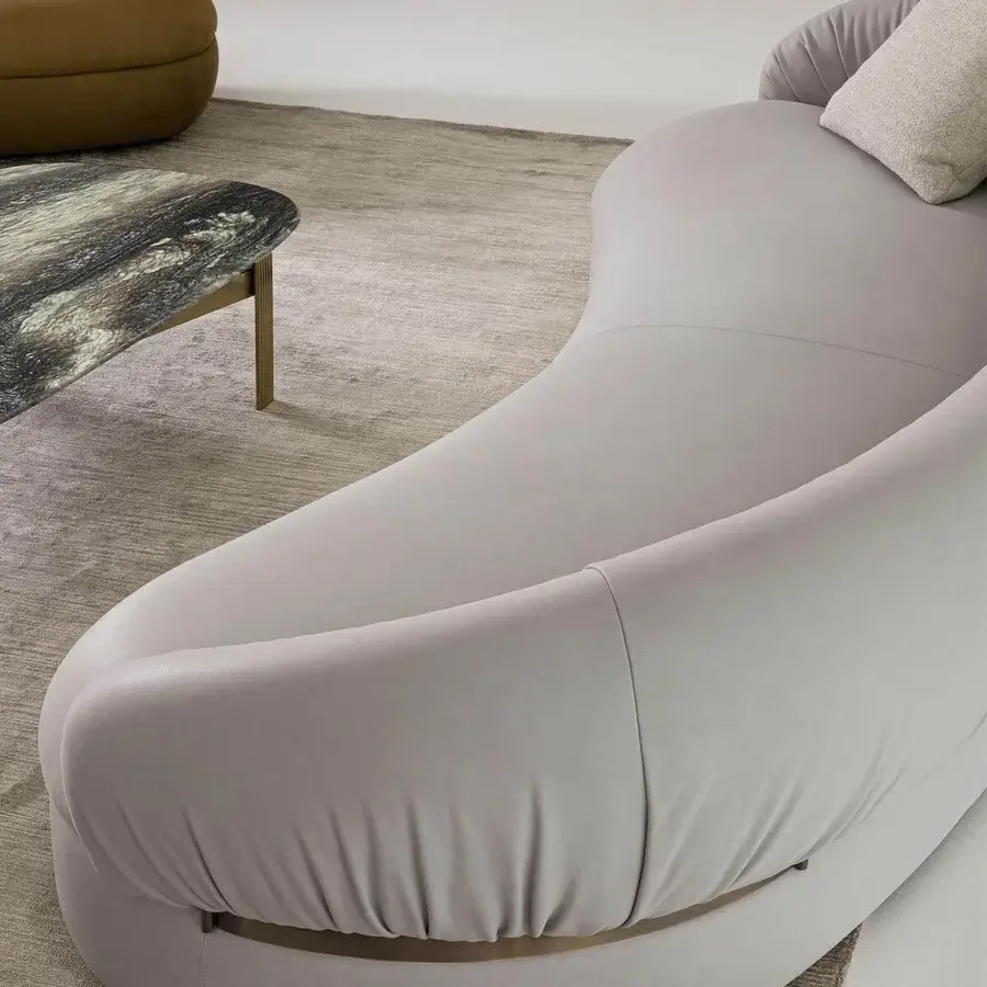 Exceptional Rugiano Fandango sofa with rounded forms, light grey leather and bronze brass metal detail