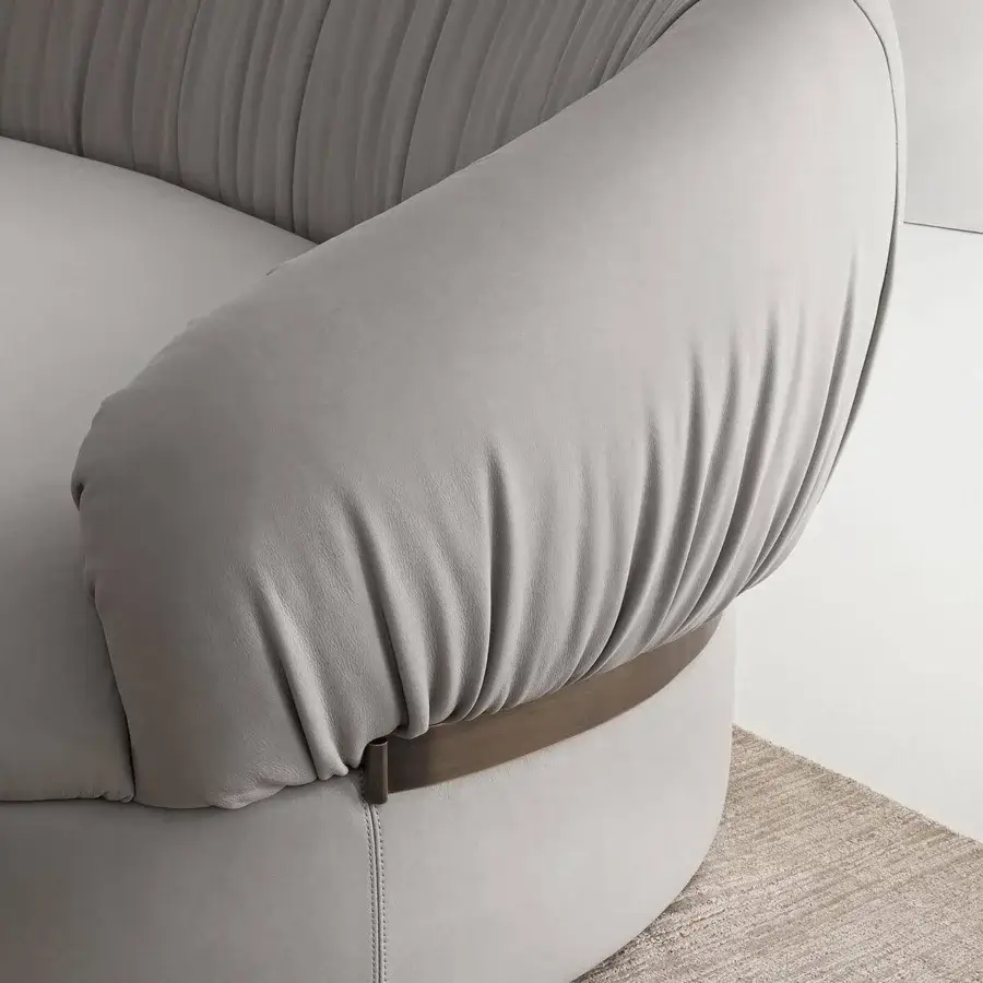 Lavish Rugiano Fandango sofa with a gracefully curved silhouette, light gray leather and bronze brass metal accents
