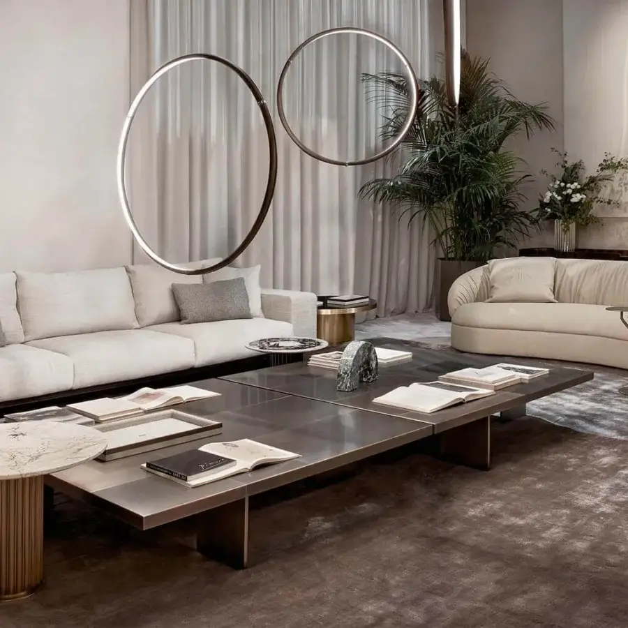 Distinguished Rugiano Fandango sofa with a curved silhouette, light beige textile upholstery and bronze brass metal detailing