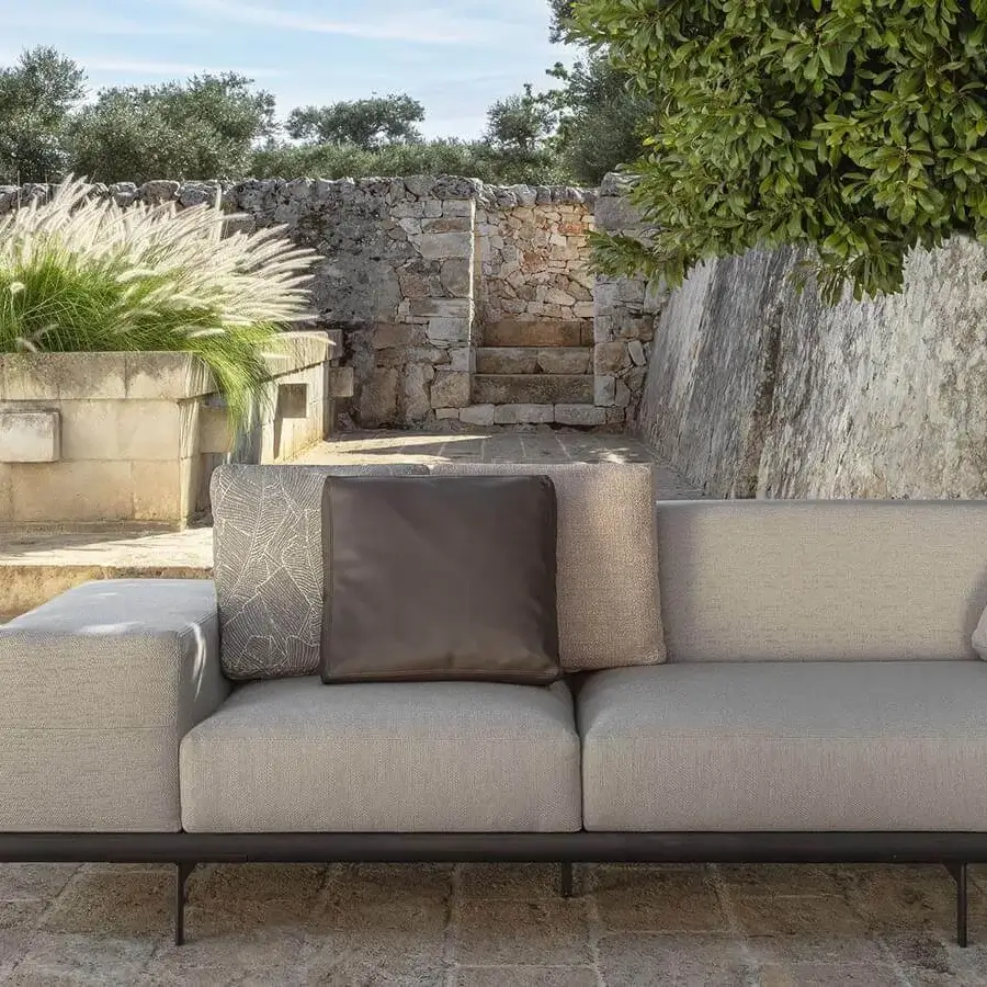 Distinguished Talenti Allure sofa with light gray textile upholstery, geometric cushions and a sleek metal frame crafted in Italy