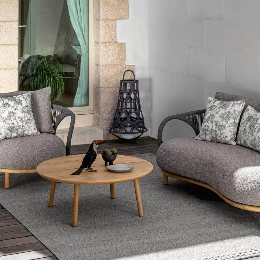 Distinguished Talenti Karen sofa with woven gray synthetic frame, textured gray upholstery and botanical pillows