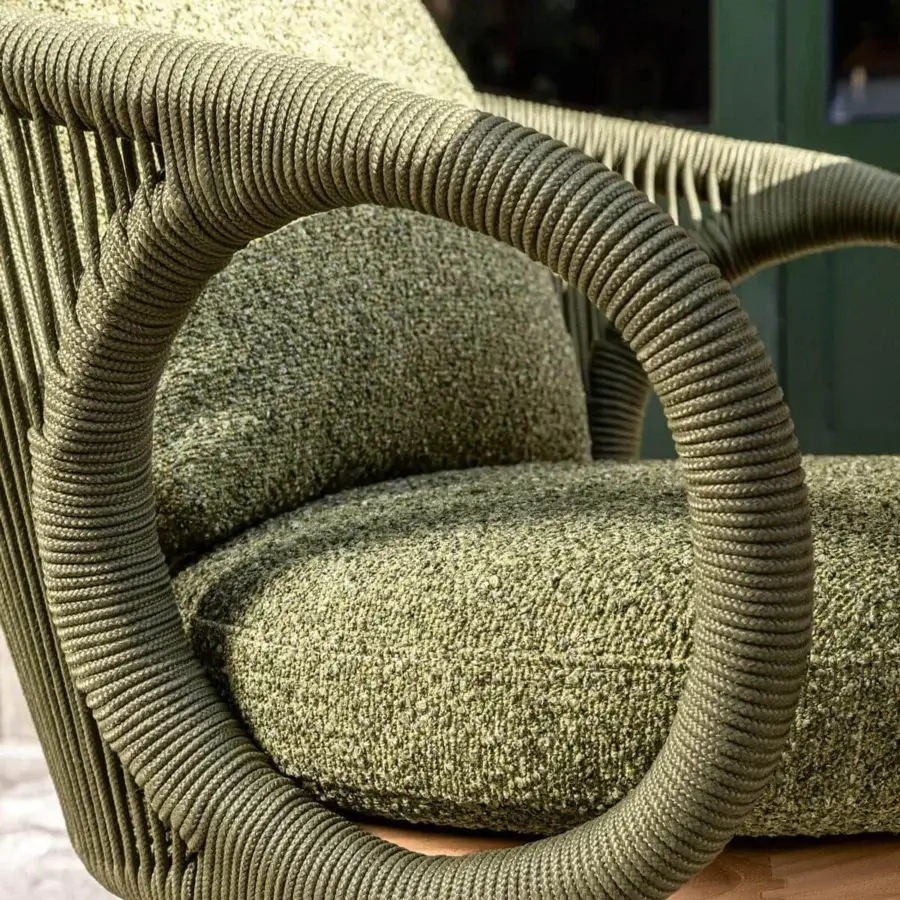 Elegant Talenti Karen lounge chair with curved lines and woven green rope material, built with a visible wooden base and plush cushions