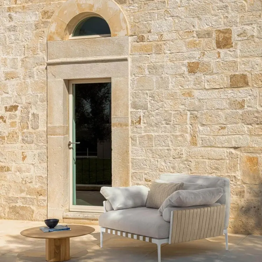 Distinctive Talenti Salinas lounge chair with light gray textile cushions and matte white metal frame built with light brown accents