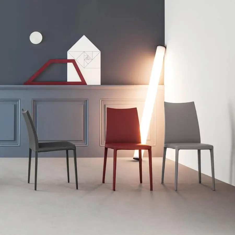 Sophisticated Bonaldo Kayla chair with compact form and low curved backrest in matte textile with satin metal legs