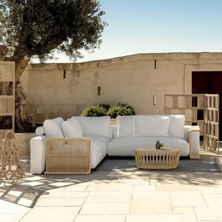 Distinguished Talenti Cliff Déco sectional with bright white textile upholstery and woven nautical rope detailing on a fully aluminum frame