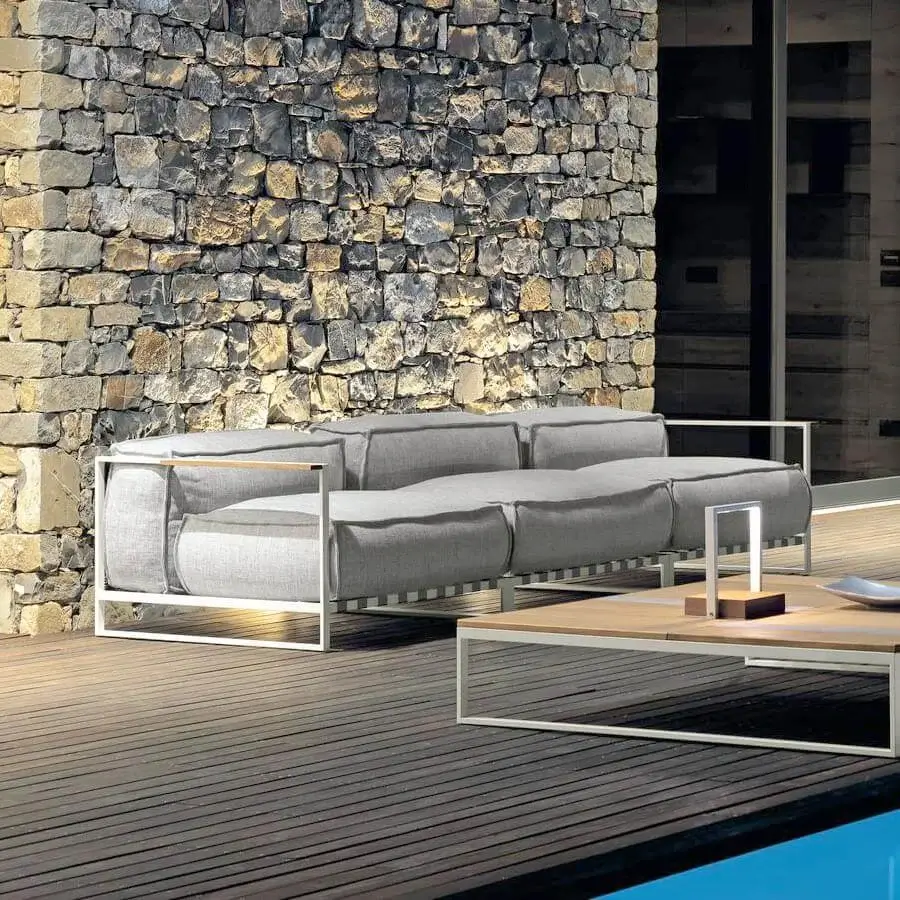 Sophisticated Talenti Casilda sectional with light gray woven fabric upholstery and unique stone wood slat detailing on a sleek stainless steel frame
