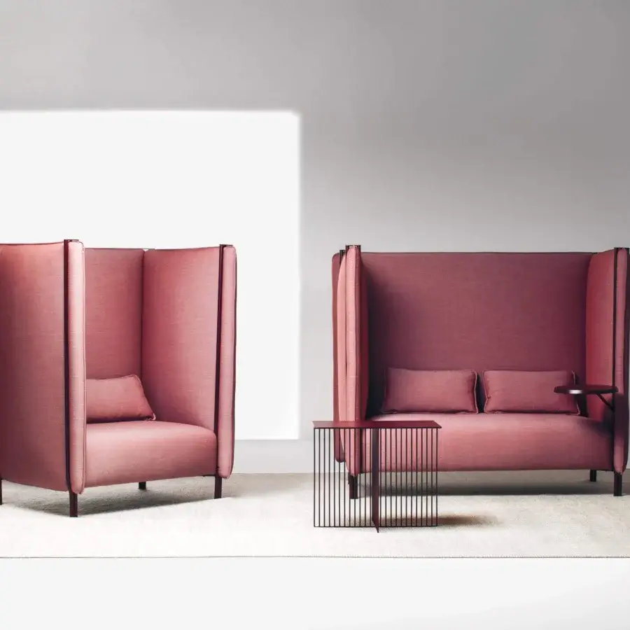 Captivating LaCividina Pinch sofa with cocoon-like form in muted rose textile and dark metal base