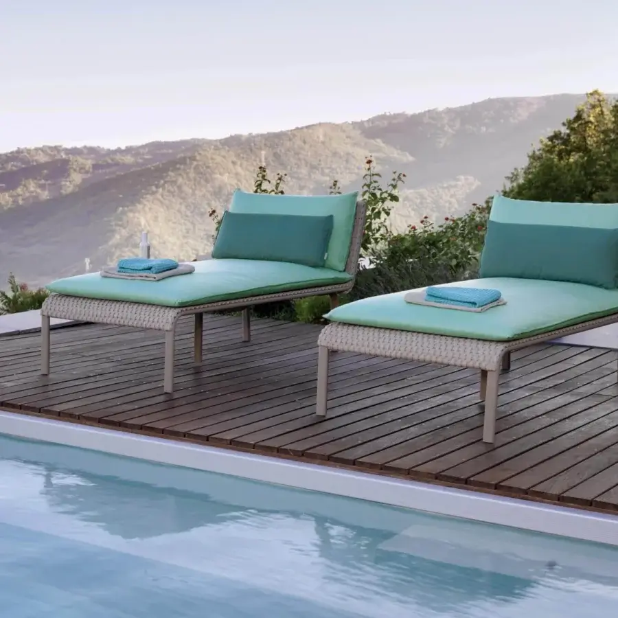 Elegant Roberti Rattan Key West lounger with hand-woven Sunrope seating and powder-coated aluminum frame in beige and teal